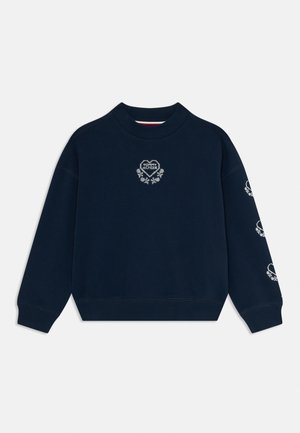 Felpa girocollo blu navy con loghi a forma di cuore floreali bianchi e testo "Tommy Hilfiger" sul petto e sul maniche destro.