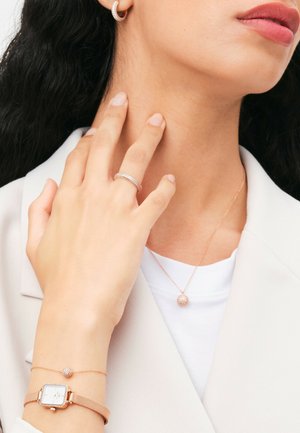 Rose gold jewelry includes a watch with a mesh band, a ring with pave accents, and a pendant necklace with a crystal ball charm.