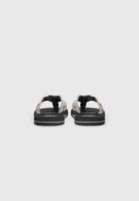 Gray textile flip-flops with black rubber soles, featuring a soft strap design and subtle logo accents on the footbed.