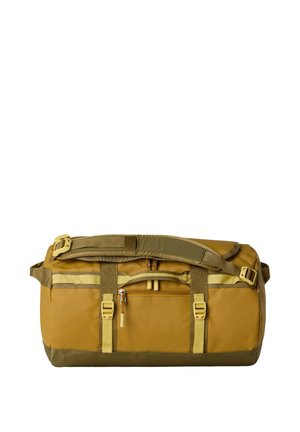 Žlutý sportovní vak s zelenými akcenty, opatřený horním uchopením, nastavitelným popruhem a jednou vnější kapsou na zip pro pohodlí.