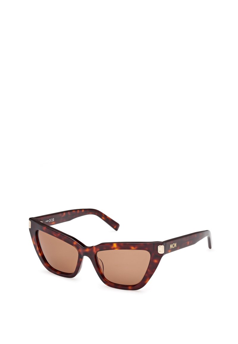 Ochelari de soare în stil tortoise cu rame unghiulare de tip cat-eye, lentile nuanțate de brun și un accent auriu pe braț, având branding-ul MCM.