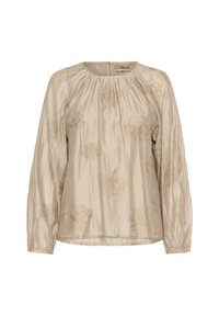 Blouse beige à manches longues, avec broderie florale en doré. Tissu lisse et brillant avec encolure froncée et poignets élastiques.