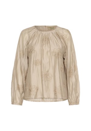Blouse beige à manches longues, avec broderie florale en doré. Tissu lisse et brillant avec encolure froncée et poignets élastiques.