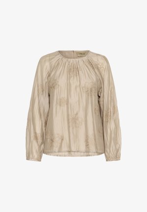 Blouse beige à manches longues, avec broderie florale en doré. Tissu lisse et brillant avec encolure froncée et poignets élastiques.