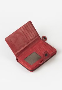 Red leather wallet with zipper closure, multiple card slots, a transparent ID window, and a snap button detail. Textured surface.