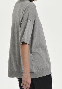 Grå oversized striktrøje med kortærmer, ribkanter og -sy, der har en afslappet pasform og blød tekstur.