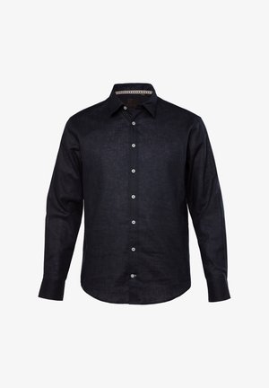 Koszula z długim rękawem w ciemnoniebieskim materiale o teksturowanym wykończeniu. Posiada kołnierzyk zapinany na guziki oraz białe guziki wzdłuż przodu.