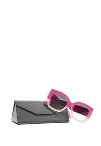 Occhiali da sole rosa oversize con montatura sfumata, abbinati a una custodia nera angolare e texture. Le lenti degli occhiali sono scure e presentano accenti audaci.
