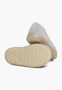 Espadrille en suède gris avec une semelle en jute d'espadrille, dotée d'une semelle en caoutchouc texturée avec un motif en vagues. Détails cousus sur la tige.