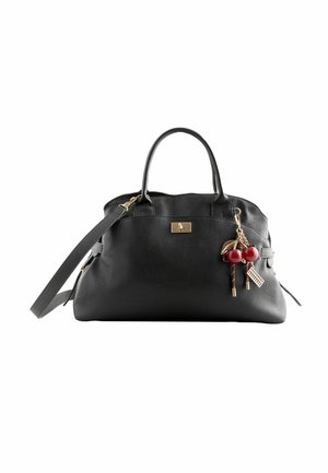 Black leather handbag with dual handles and a removable shoulder strap, featuring decorative charms including red cherries and a keychain.