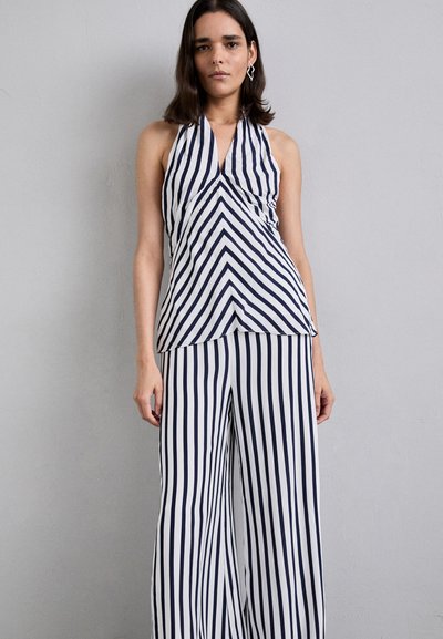 Navy and white striped halter top with a pointed hem, paired with wide-leg striped pants. Smooth texture with a fitted bodice design.