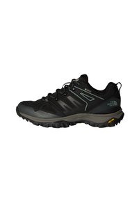 Black trail shoe with mesh upper, grey accents, and rugged Vibram outsole. Features lace-up design and supportive structure for outdoor use.