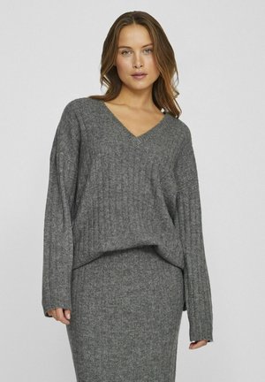 Pullover grigio a maglia con scollo a V, texture a coste e maniche lunghe, abbinato a una gonna coordinata per un look armonioso.