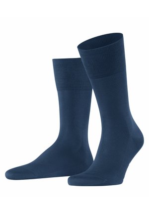 Dunkelblaue Socken aus weichem, dehnbarem Material. Mit einem gerippten Bündchen und einer glatten Oberfläche ausgestattet, die für Komfort und Passform sorgt.