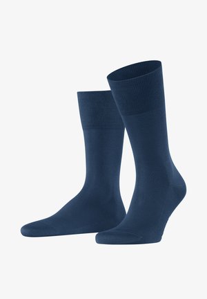 Calzini blu scuro realizzati in materiale morbido e elastico. Presentano un polsino a coste e una texture liscia su tutta la superficie, progettati per il comfort e la vestibilità.