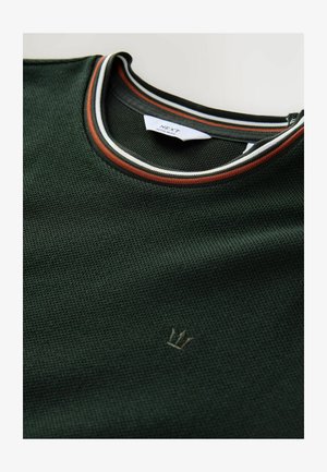 Green textured short-sleeve shirt with a ribbed collar featuring white, black, and rust-colored stripes. Small crown logo in the bottom corner.