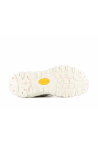 Semelle en caoutchouc blanche avec un motif de semelle texturé, arborant un logo Vibram jaune au centre. Design épuré et fonctionnel pour une bonne adhérence.