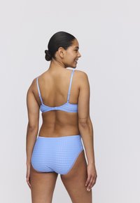Completo bikini blu chiaro con motivo a scacchi. Il top ha spalline regolabili e il fondo ha una finitura liscia con vita.