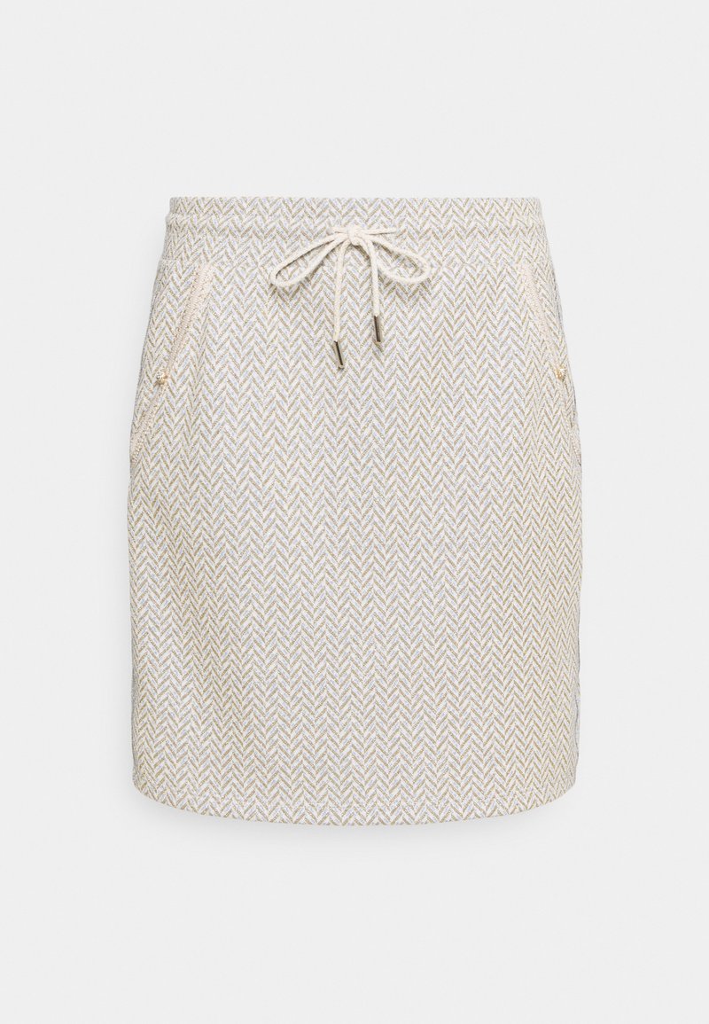 Jupe beige longueur genou avec motif chevrons blanc, taille à cordon et poches latérales zippées sur fond blanc.