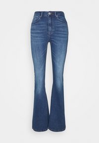 Levisit väljendid tume pesu teksad. Kõrge vöökoht, viie tasku disain, nähtav õmblus ja kerge pleekimine põlvede ja ääride juures.