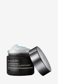 Barattolo di vetro nero contenente crema azzurro chiaro, con coperchio metallico argentato parzialmente aperto. Il testo sull'etichetta indica il nome e il tipo del prodotto.