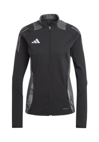 Veste de sport noire avec des accents gris, fermeture éclair, panneaux texturés et poches latérales. Fabriquée en tissu extensible et évacuant l'humidité.