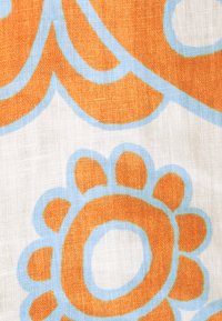 Tessuto di cotone con sfondo bianco, caratterizzato da audaci motivi floreali arancioni contornati da blu chiaro. Trama texturizzata visibile.