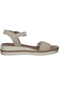 Sandales à plateforme beiges avec un dessus lisse, une sangle de cheville réglable et une semelle en liège texturée. Dotées d'une épaisse semelle en caoutchouc blanche.