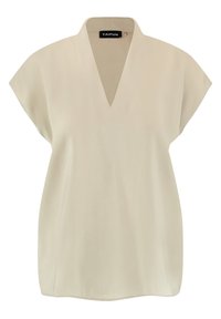 Beige topp med V-ringning och korta ärmar. Slät textur, avslappnad passform och rundad nederkant. Varumärkesetikett synlig vid halsringningen.