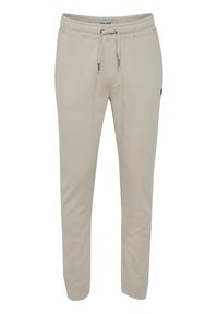 Beige joggers lavet af en blød, strækbar bomuldsblanding. Har en elastisk talje med snøre og tapered manchetter.