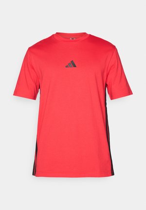 Red short-sleeve t-shirt with round neck, featuring a black Adidas logo on the chest and black side stripes. Made from soft fabric.