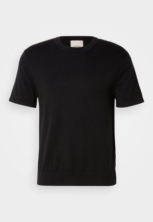 Black short-sleeve T-shirt made of soft cotton. Features a round neck, ribbed texture, and a subtle logo accent on the chest.