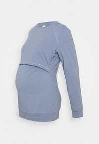 Felpa maternità azzurro chiaro con maniche lunghe, scollatura tonda e design a strati per accogliere un pancione in crescita. Texture liscia.