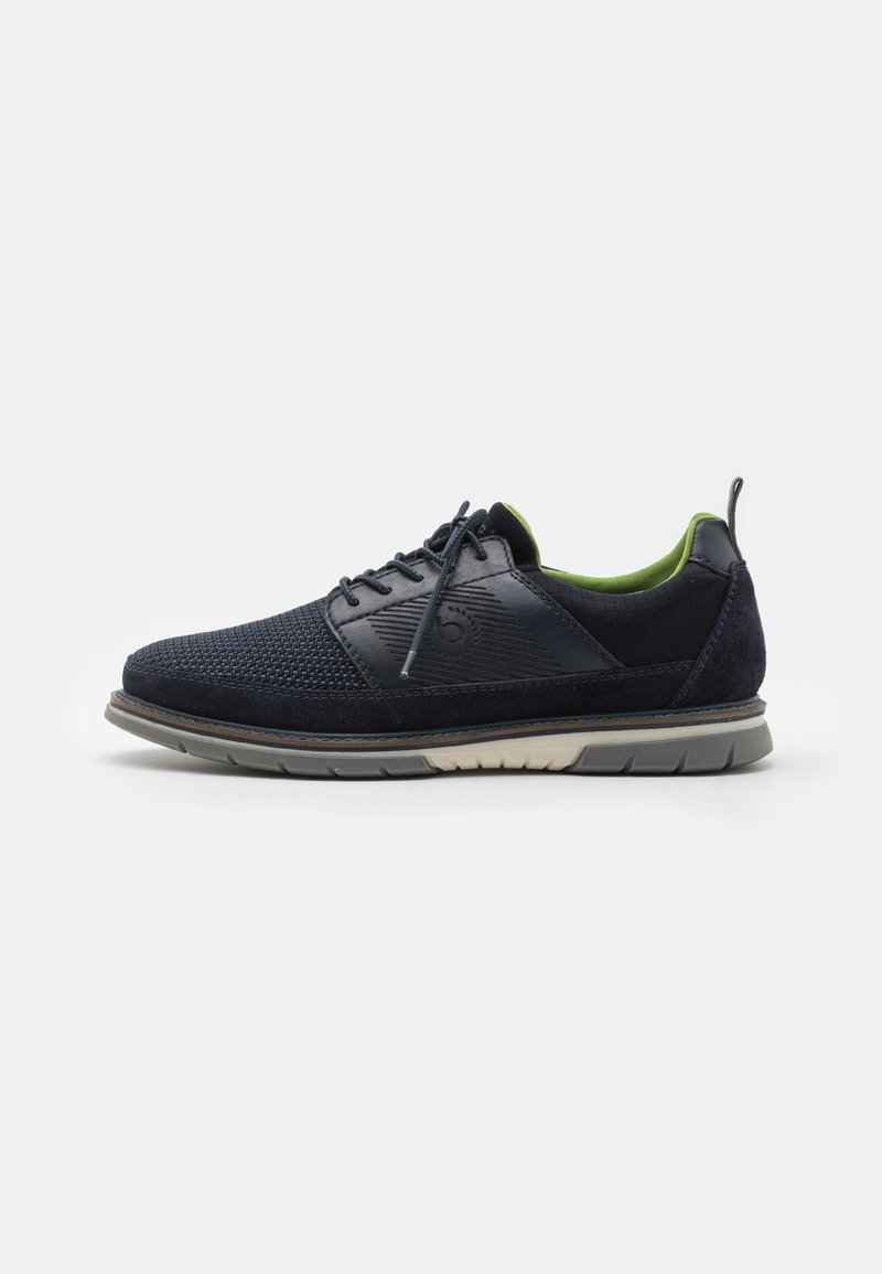 Navy blue lace-up shoe featuring a textured knit upper and smooth leather accents, with a contrast green lining and a flexible rubber sole.