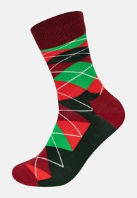 Calzino multicolore con un motivo geometrico in rosso, verde, nero e bianco. Realizzato in un tessuto morbido con un polsino a costine.