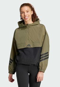 Olive green and black windbreaker with a cropped design, featuring a zippered front, hood, and black three-stripe accents on sleeves.