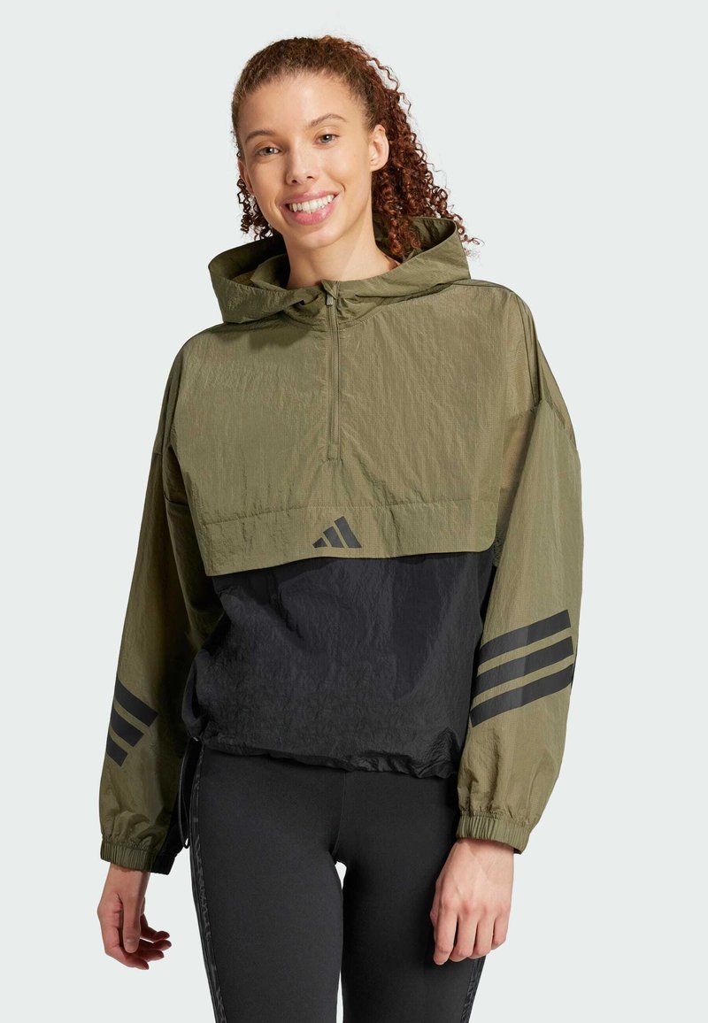 Olive green and black windbreaker with a cropped design, featuring a zippered front, hood, and black three-stripe accents on sleeves.