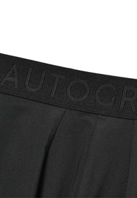 Pantalones negros con una cinturilla texturizada que presenta la palabra "AUTOGRAPH" en relieve. Tejido suave con un diseño a medida y detalles con pliegues.