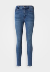 Jeans skinny de mezclilla azul con cintura alta, que presentan un ligero desvanecimiento, bolsillos frontales y un cierre de cremallera con botón.