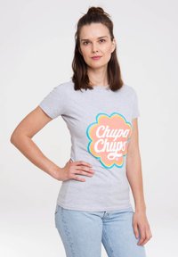 Gray T-shirt featuring a colorful Chupa Chups logo. Short sleeves, slim fit, smooth cotton fabric, round neckline, and pastel accents.