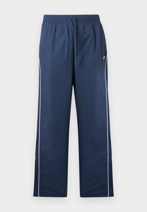 Pantalones deportivos azul marino con cintura elástica, cordón ajustable, ribete blanco lateral y pequeño logo en el lado superior izquierdo.