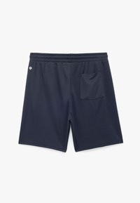 Navyhousut pehmeästä kankaasta, jossa on joustava vyötärönauha, takatasku ja pieni logo vasemmalla puolella.