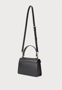 Black leather crossbody bag with a top handle, gold hardware, and structured design. Features an adjustable strap and a flap closure.