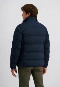 Donkerblauwe pufferjas met een hoge kraag, gewatteerd ontwerp en elastische manchetten. Glad, lichtgewicht materiaal met een relaxte pasvorm.