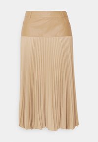 Plisserad kjol med en hög, slät lädermidja i ljusbeige färg. Har lätt och flödande tyg med vertikala plisseringar.