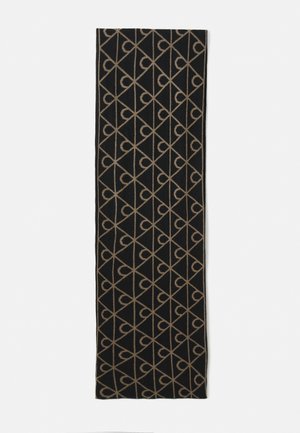 Zwarte rechthoekige sjaal met een herhalend beige geometrisch patroon van diagonale lijnen en gestileerde gebogen vormen.