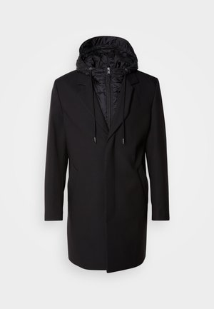 Black coat with a detachable padded hood, zip closure, side pockets, and a tailored design. Smooth texture and clean lines throughout.