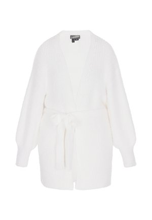 Cárdigan blanco de punto con mangas largas, frente abierto y cinturón de lazo. Presenta una textura esponjosa y detalles acanalados en las mangas.