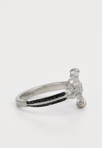 Silver ring with a textured floral design on top, featuring a band accentuated by black stones along the center for contrast.