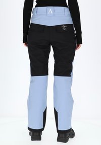 Warm ski pants with a blue and black color scheme, featuring multiple pockets, a high waistband, and durable, textured fabric.